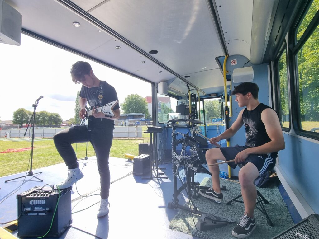 Two youngster playing in a band